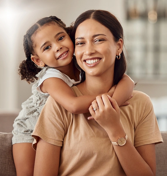 Mother and daughter smiling together, showcasing warmth and connection, representing family support and emotional well-being in a counseling context.